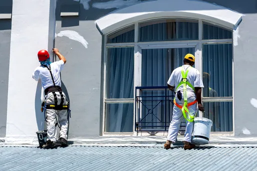 Two painters on harnesses repainting a business park facade in Chatsworth
