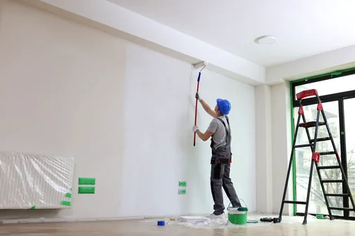 Painter rolling a clean white office wall inside a Chatsworth industrial building
